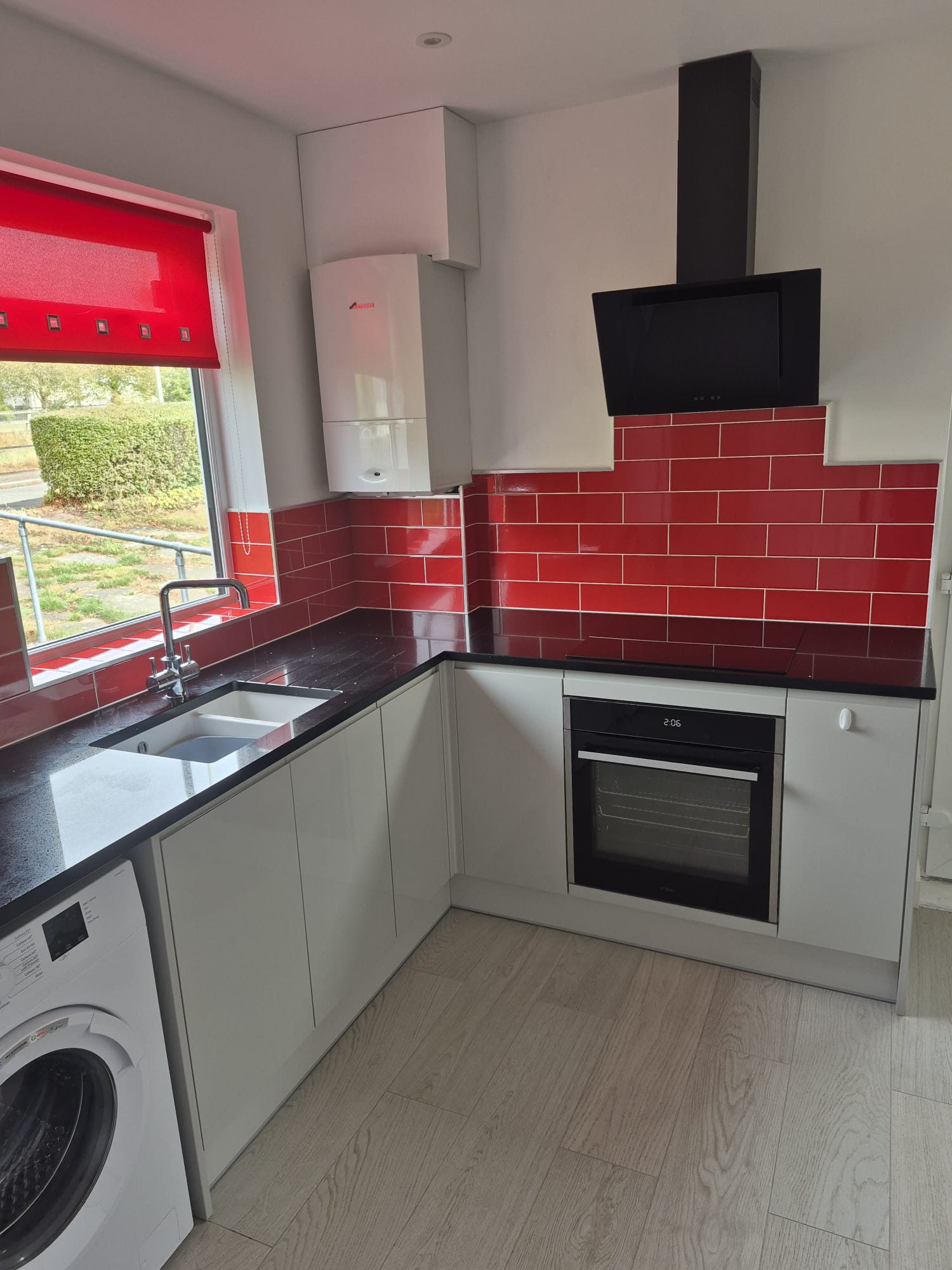 Kitchen stripped back to brick and rebuilt in gloss cashmere