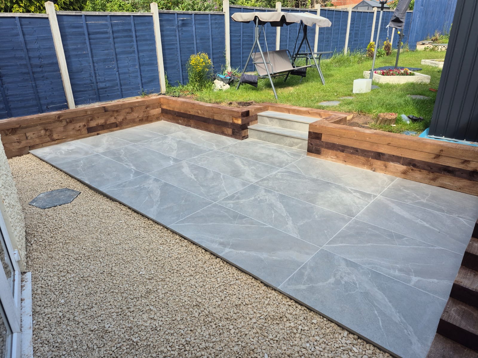 Porcelain patio with sleeper beds and steps