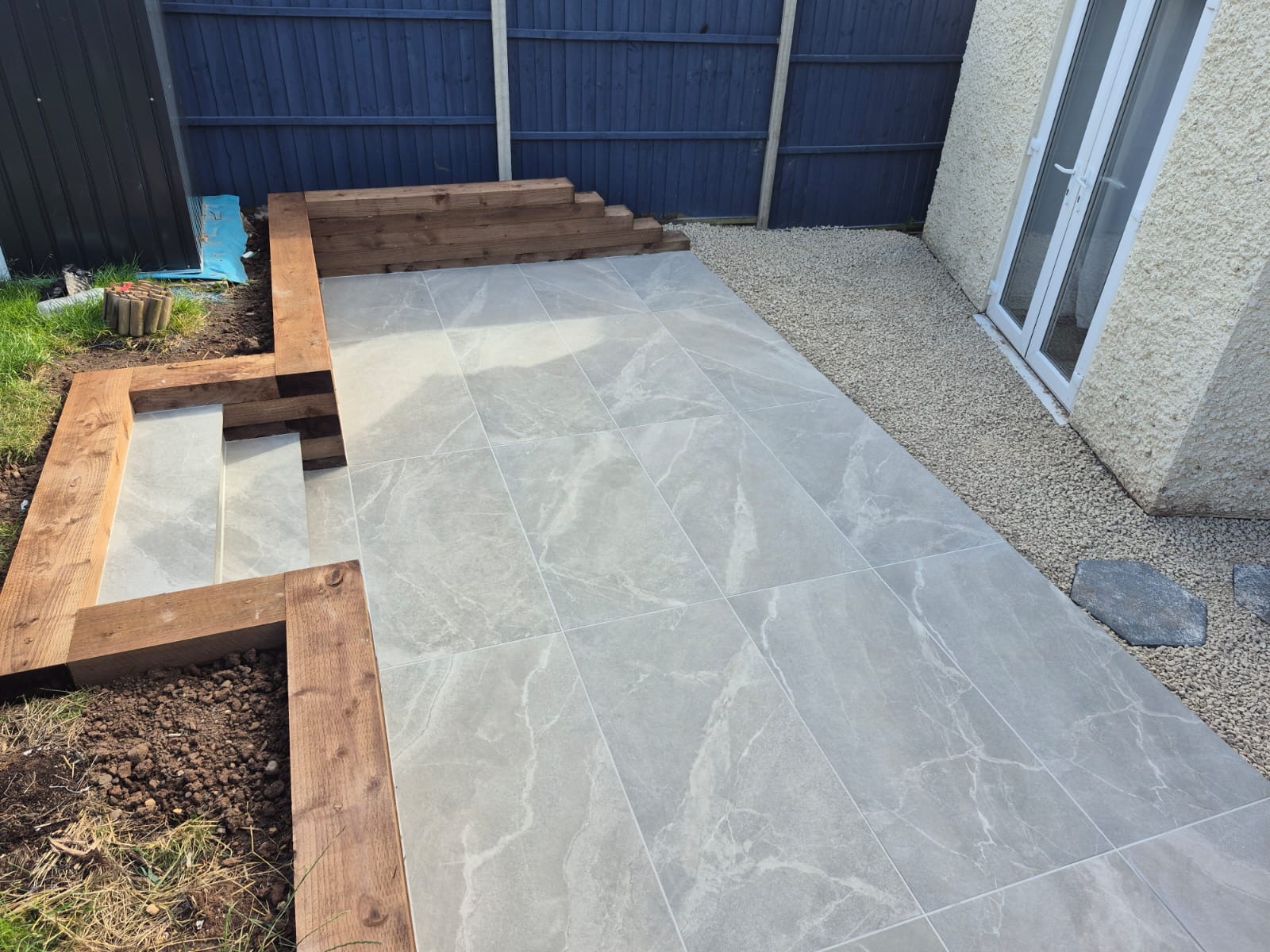 Porcelain patio with sleeper beds and steps
